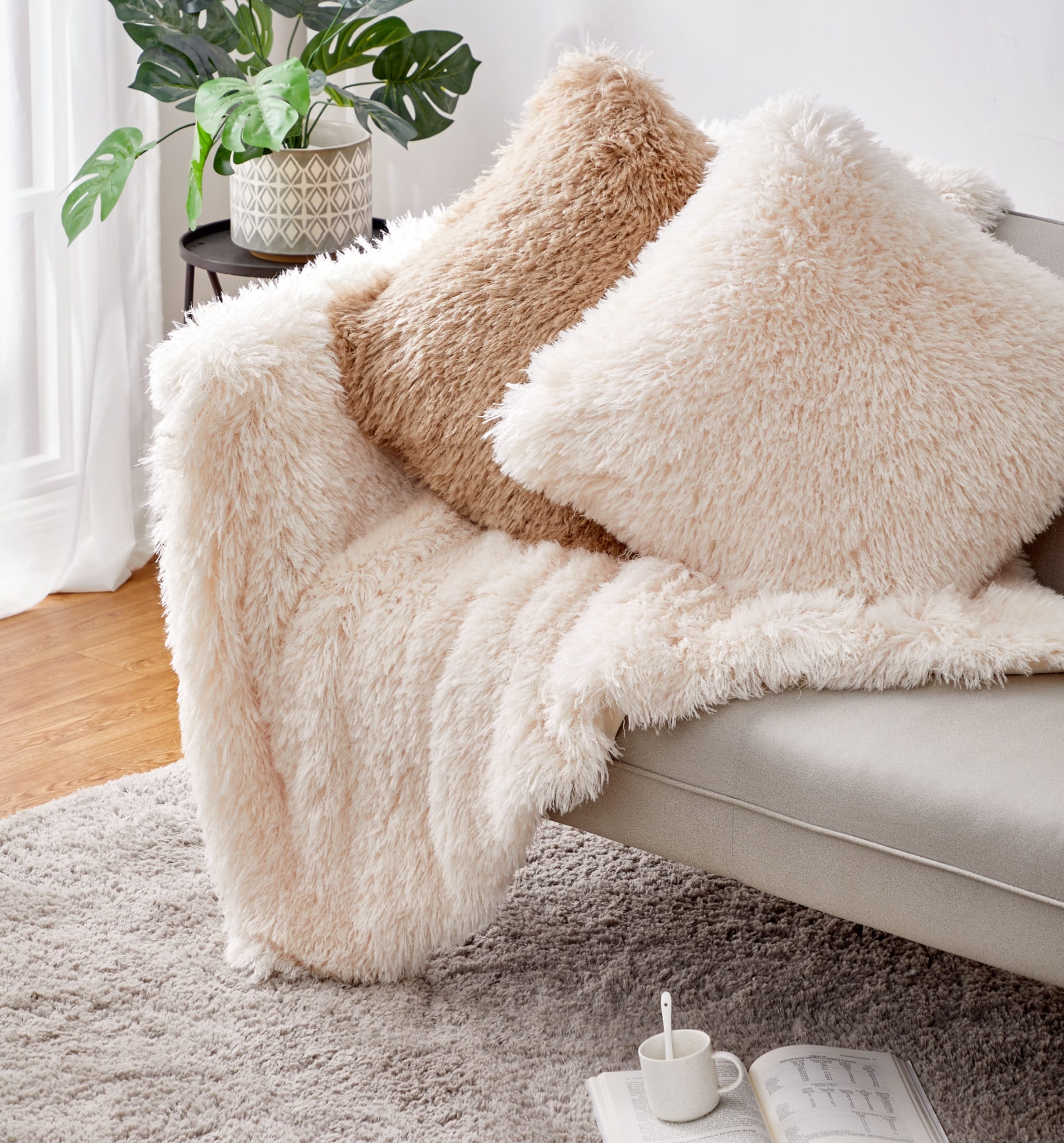 Plush blanket and coordinating pillows photographed close enough to show pile