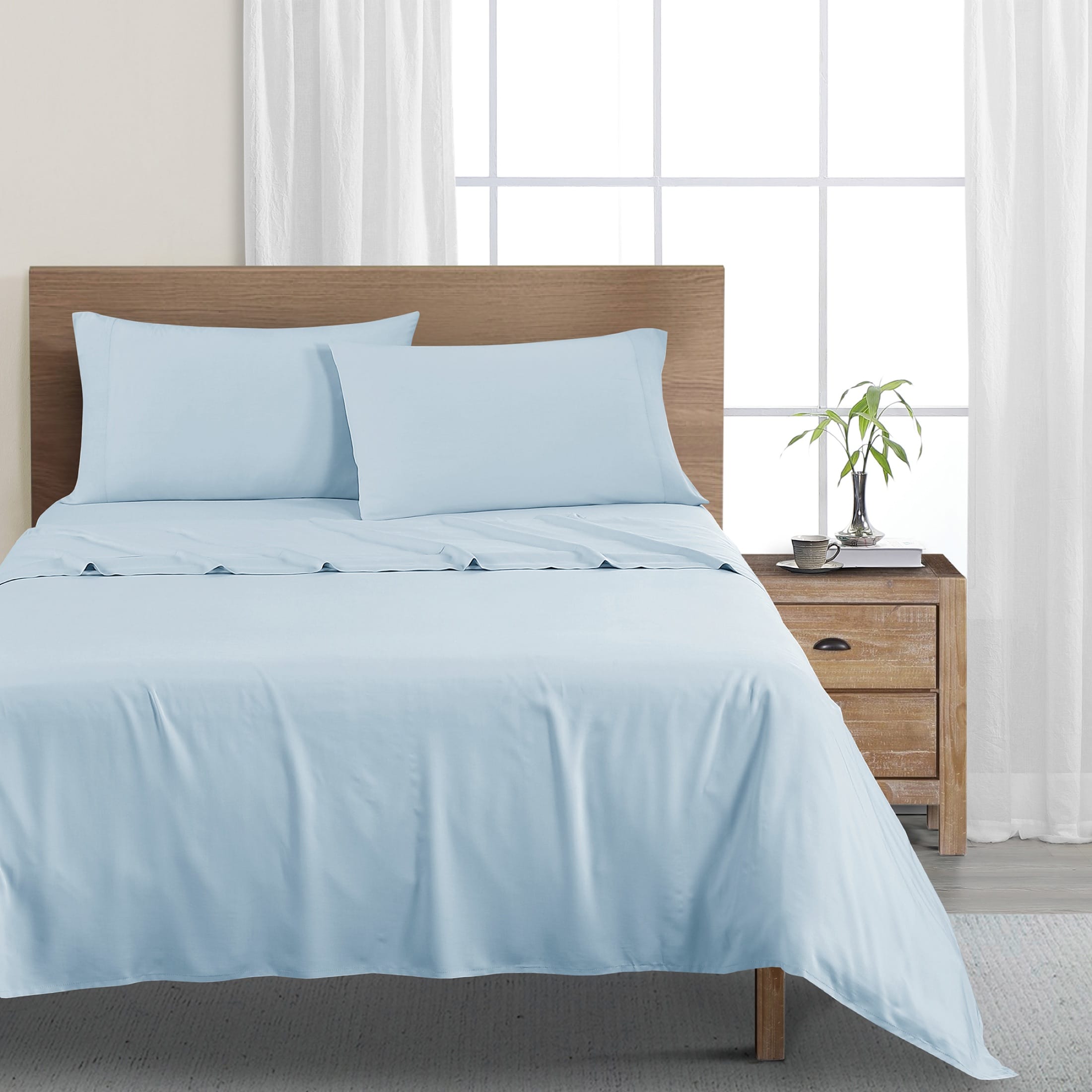 Blue sheet set photographed as a complete made bed